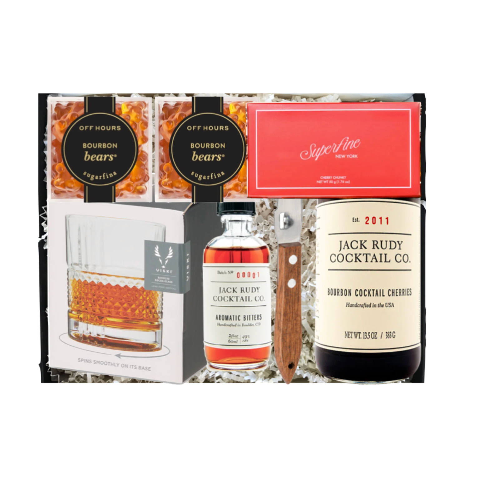 Gift set with Jack Rudy cocktail cherries, bourbon bears, and a glass on a white background