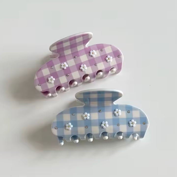 Two checkered bunny-shaped hair clips on a light gray background