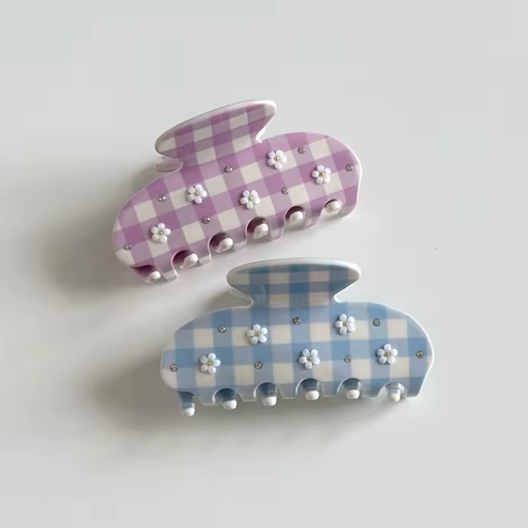 Two checkered bunny-shaped hair clips on a light gray background