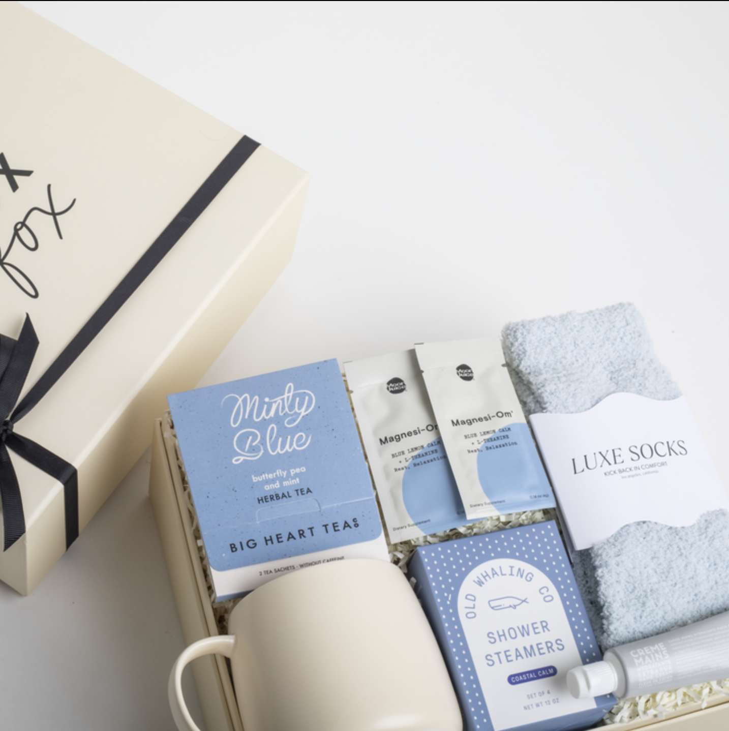 Gift set with tea, socks, and other items on a white surface