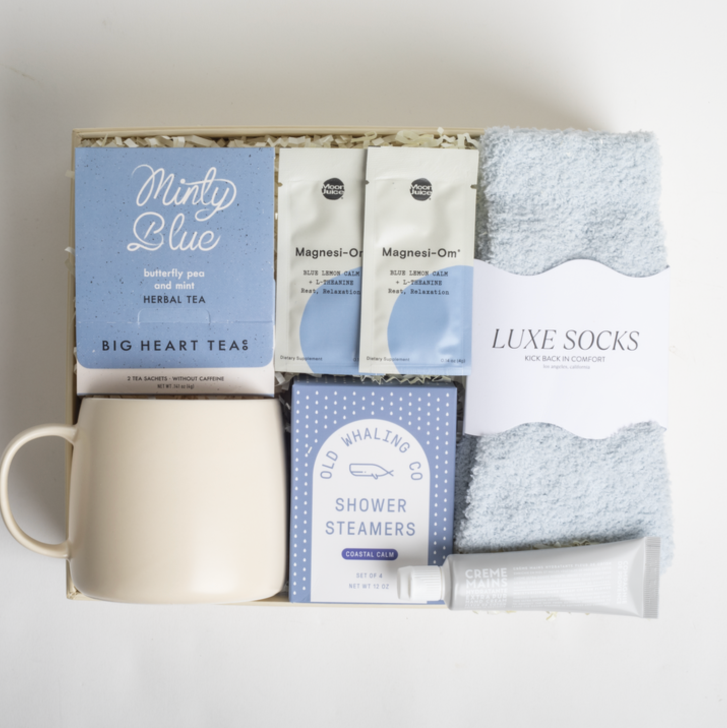 Gift set with tea, socks, and other items on a white background