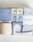 Gift set with tea, socks, and other items on a white background