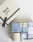 Gift set with tea, socks, and other items from Box Fox on a light background