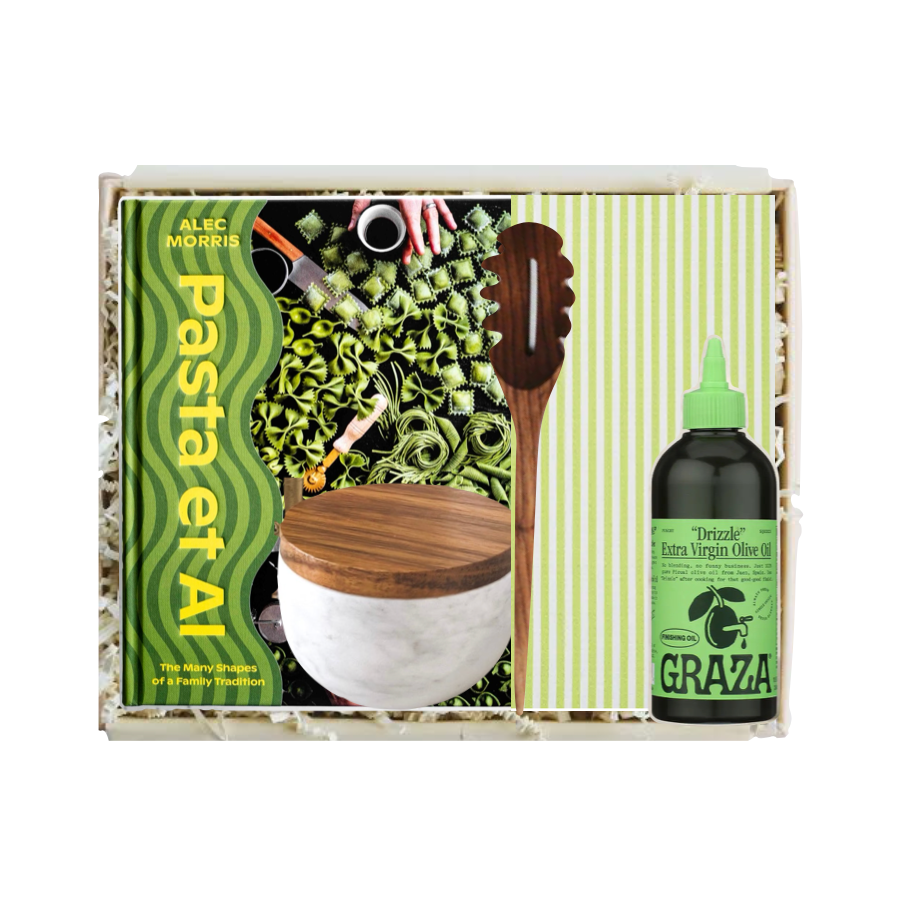 Pasta making kit with a wooden spoon, bowl, and bottle of olive oil on a white background