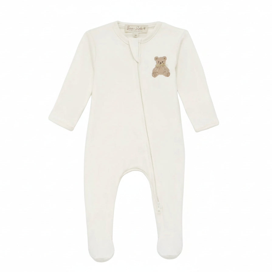An off-white long-sleeve baby footed sleeper with a small embroidered teddy bear on the chest, shown against a plain white background.