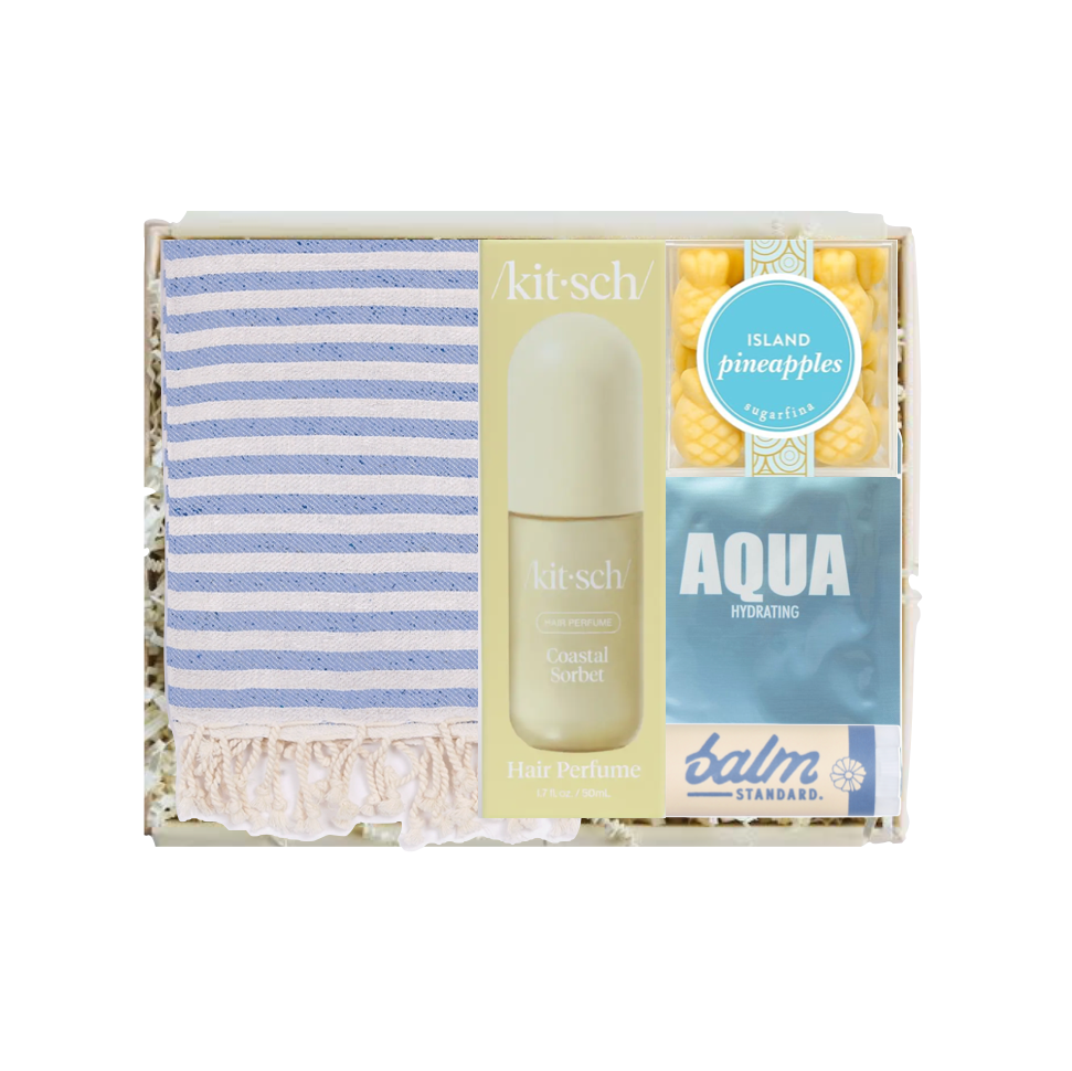 Kitsch perfume set with striped towel and 'Aqua' bottle on a white background