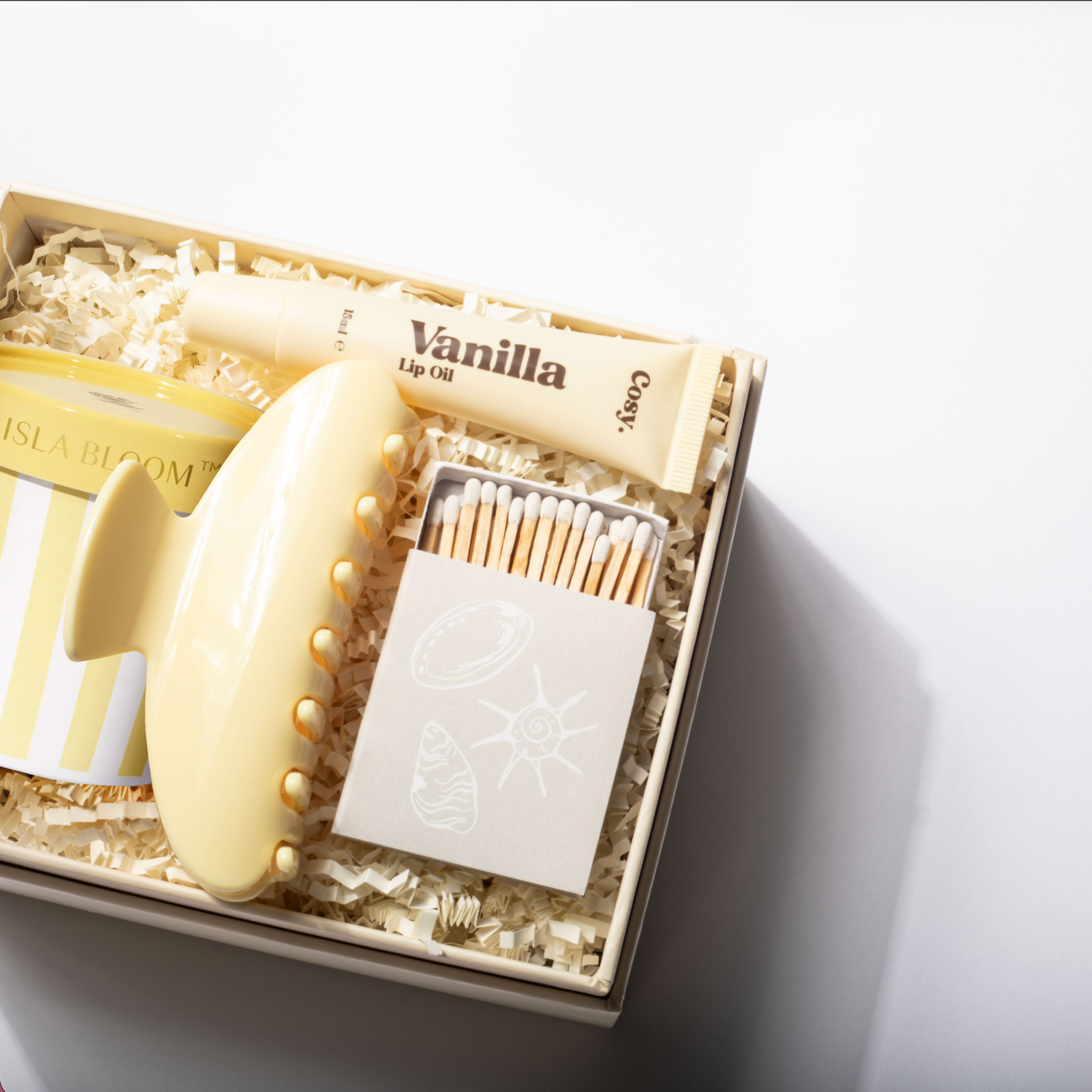 Vanilla-scented product set with matches on a light gray background