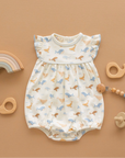 whale tales romper on an orange background