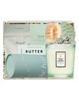 A curated gift box set containing a Holiland French Gardenia scented candle, a light blue cylindrical tin, a white pouch of Butter, a green soap bar, and a succulent, arranged in a box with gold crinkle paper.