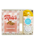 A curated gift box set from Meli's and Voluspa, featuring a box of Chocolate Chip cookie bites, a Voluspa Cocoon of Voluspa Garcinia & White Sugar cookies, and a yellow and blue birthday cake cookie bite packet, arranged in a white box with shredded paper.