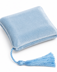 A light blue velvet square cushion with a matching blue tassel, shown on a white background.