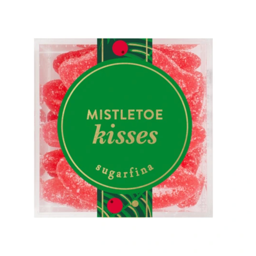 A package of Mistletoe Kisses Sugarfina gummy candies, featuring red sugar-coated gummies visible through a clear plastic container with a green holiday-themed label.