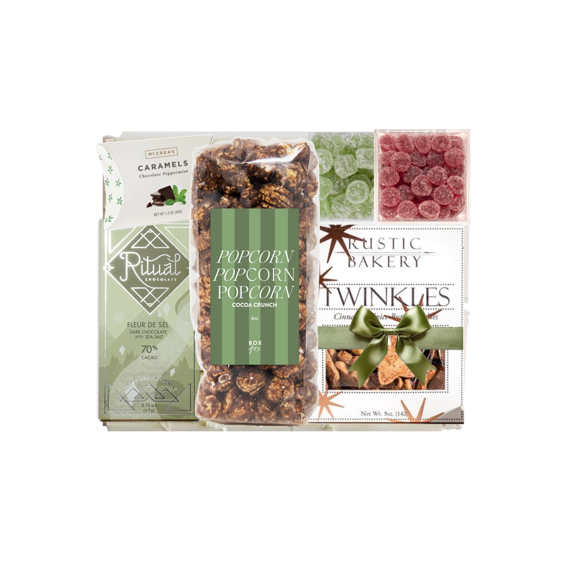 A gift set from Rustic Bakery featuring caramel corn, peppermint popcorn, caramels, and Twinkies, packaged in a white box with green accents and a clear window showing the treats inside.