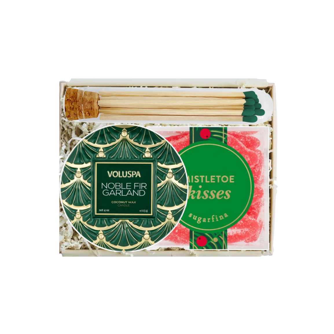 A boxed gift set containing a round green and gold patterned Voluspa Noble Fir Garland, a pack of pink Twisted Kisses sugarfins, and wooden matchsticks with green tips, all arranged in a white gift box with shredded paper.