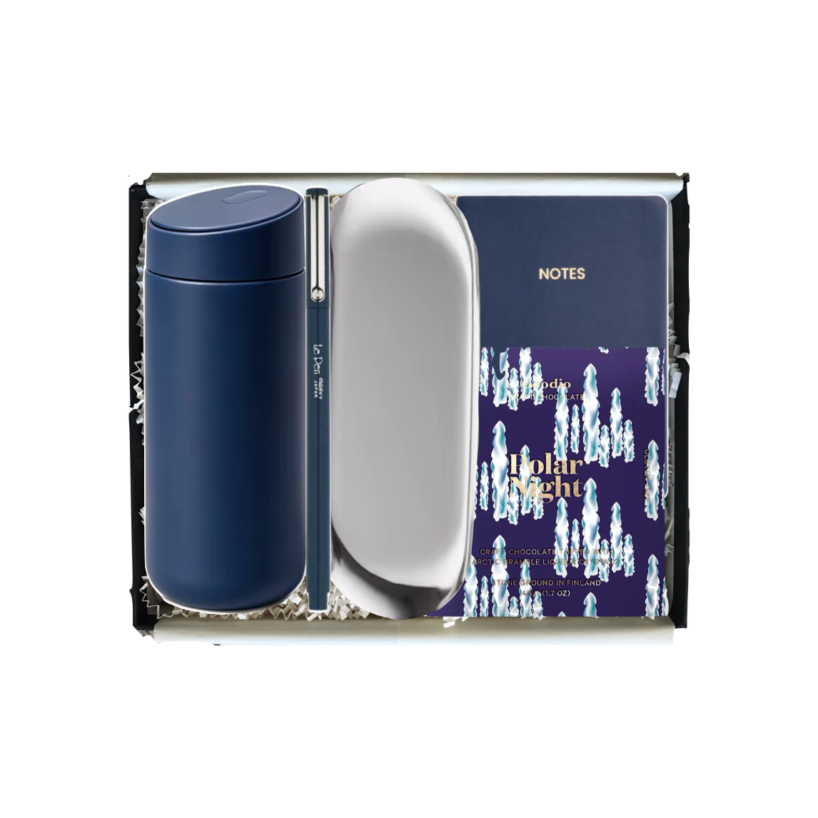 A Johnnie Walker gift set containing a navy blue tumbler, a silver oval mirror, and a blue and white patterned Johnnie Walker notes notebook inside a black gift box.