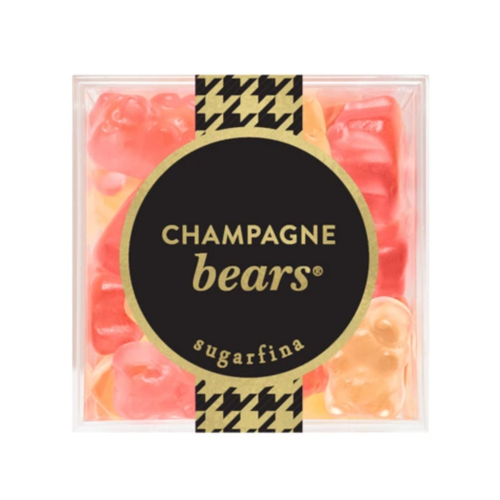 A clear square plastic container filled with pink and orange gummy bears, with a black circular label reading 'CHAMPAGNE bears' and 'sugarfina' on a white background.