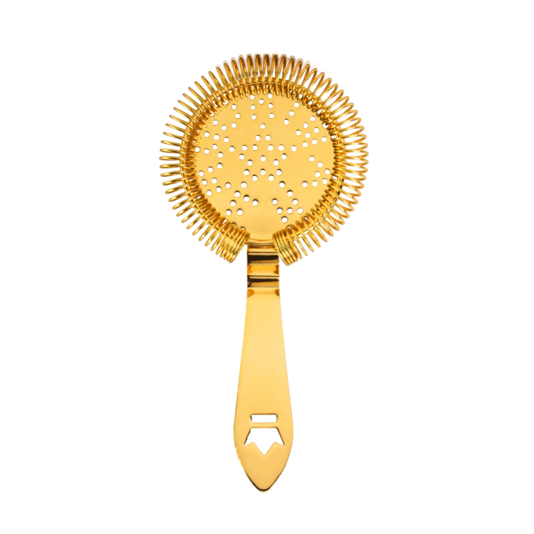 gold cocktail strainer on a white background