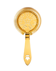 gold cocktail strainer on a white background