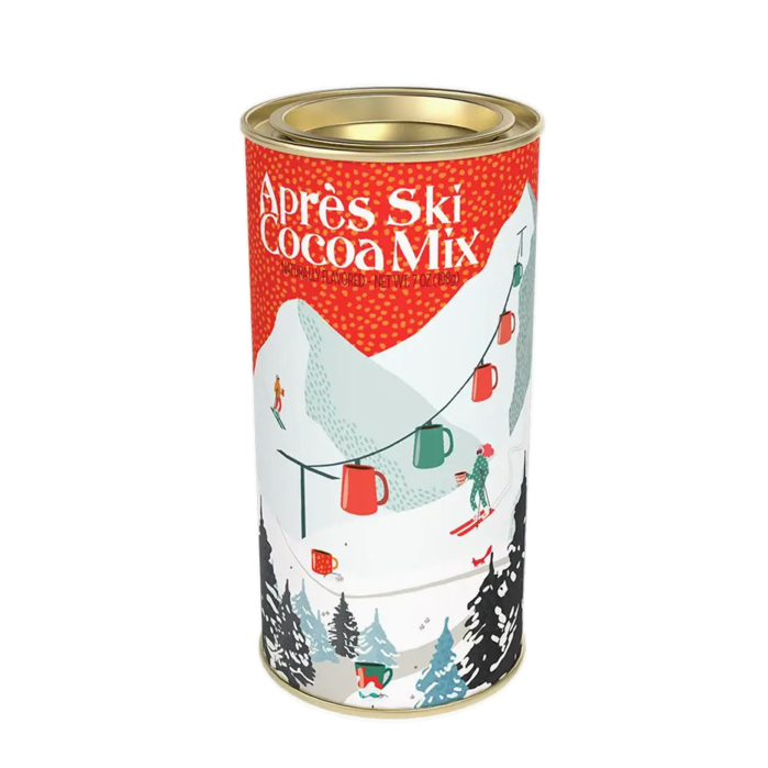 A cylindrical metal canister of Çapres Ski Cocoa Mix, featuring a festive winter ski illustration with red, green, and white colors on a white background.