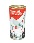 A cylindrical metal canister of Çapres Ski Cocoa Mix, featuring a festive winter ski illustration with red, green, and white colors on a white background.