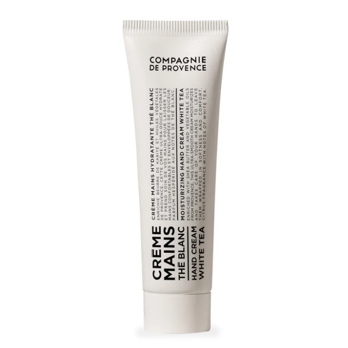 A white squeeze tube of Compagnie de Provence Creme Mains Hand Cream in White Tea scent, shown on a clean white background.