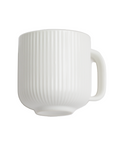 A white ceramic mug with a vertical ribbed texture and a C-shaped handle, shown against a plain white background.