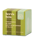A green and olive striped cardboard box for 'here's how. The Moony Glass Bottle Stopper in Olive', shown on a plain white background.