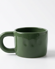 A dark green ceramic mug with a thick, rounded handle, shown on a clean white background.