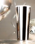 metallic tumbler on silver background with disco ball 