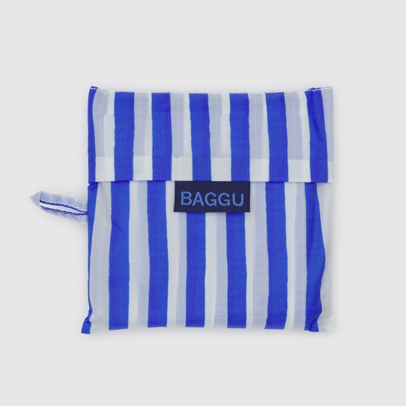 Blue and white striped reusable bag with 'BAGGU' logo on a light gray background