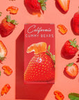 Box of California Gummy Bears surrounded by strawberries on a pink background