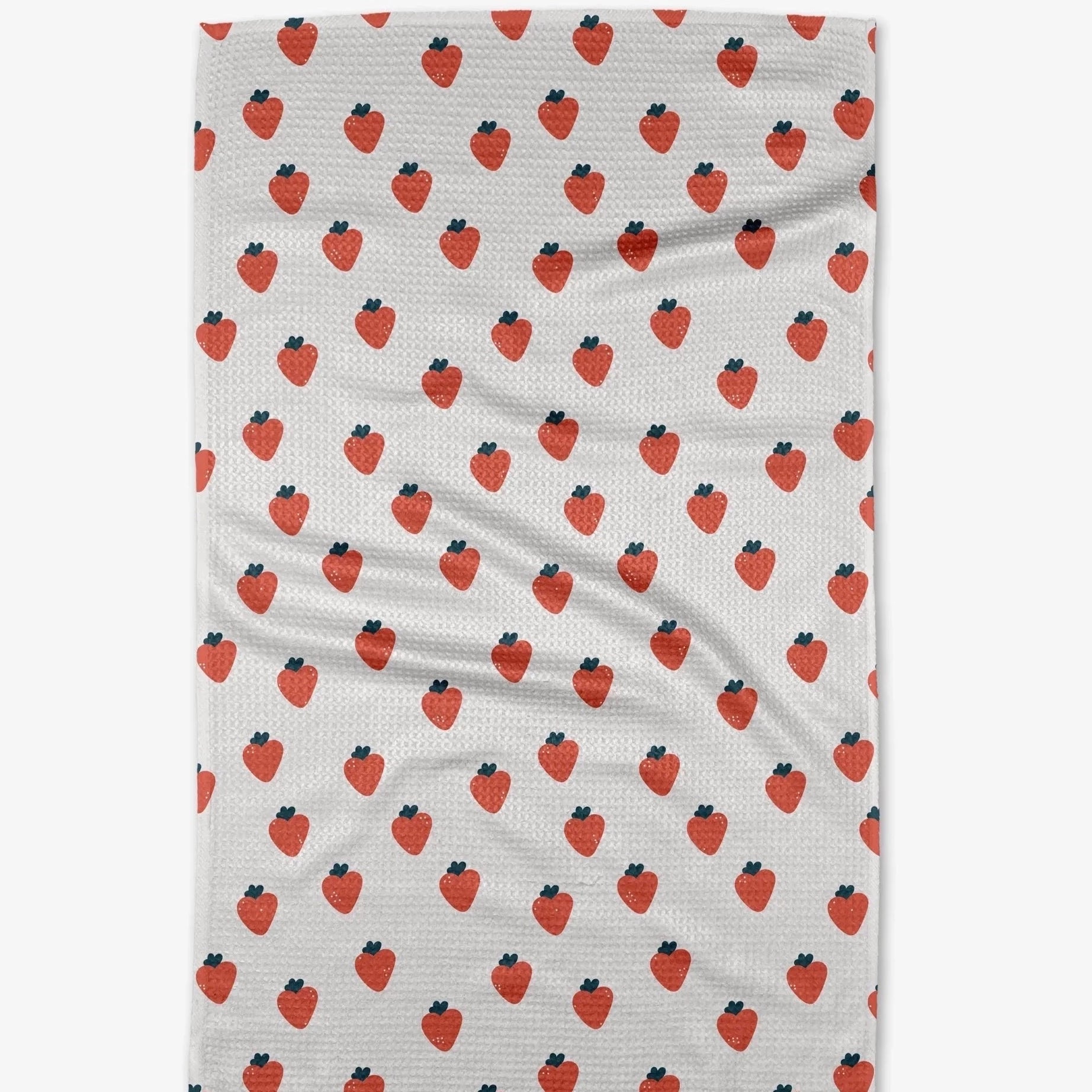 white tea towel with red strawberries printed on it