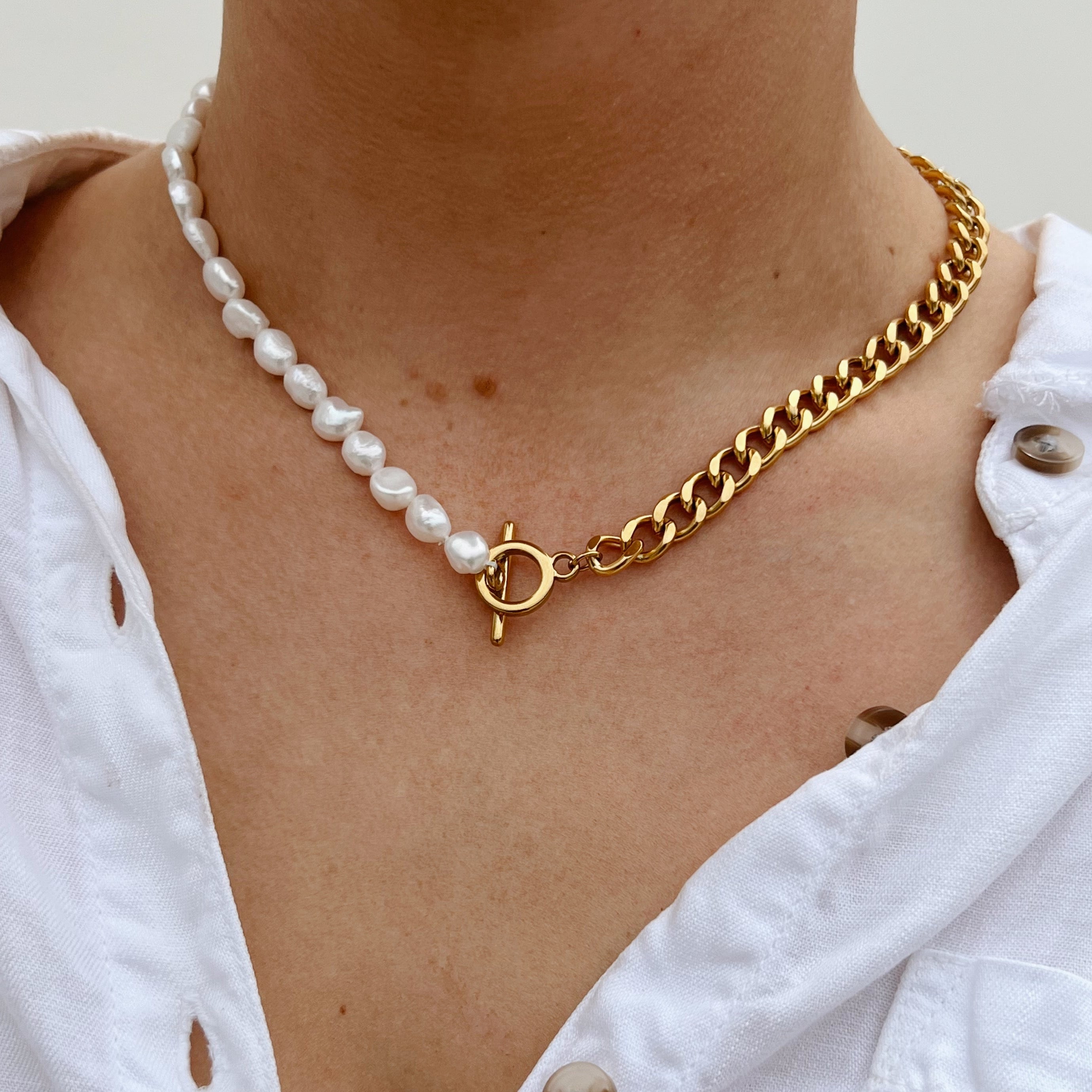 Girl wearing white shirt with pearl and chain necklace