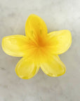 Yellow flower-shaped object on a marble surface