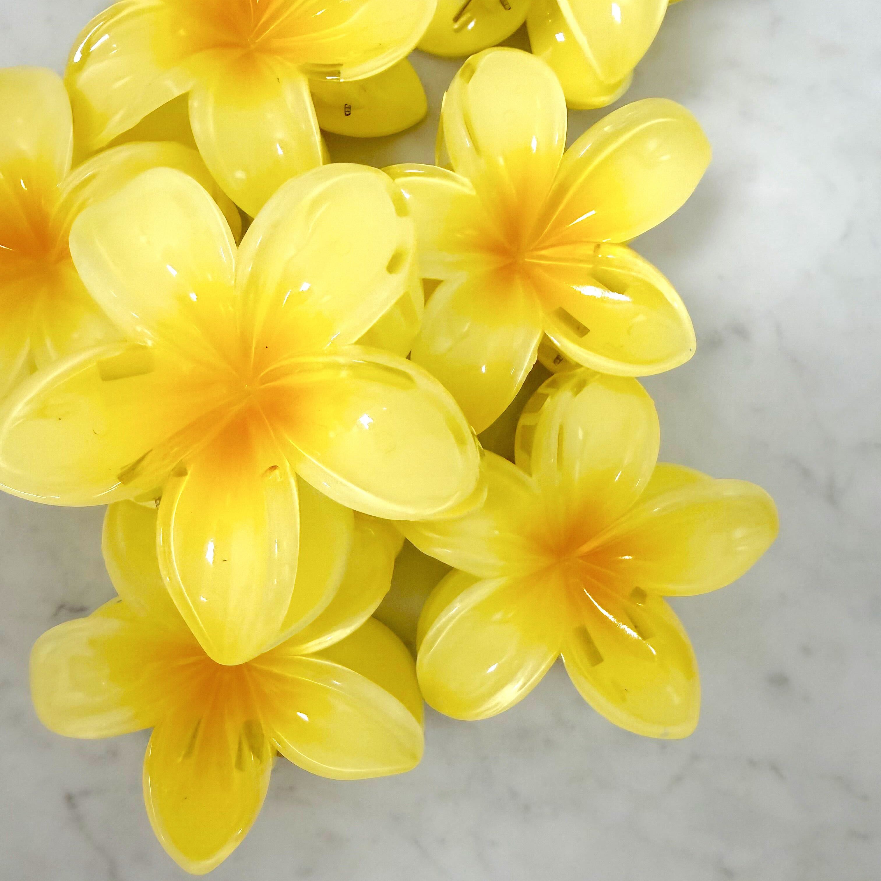 Yellow artificial flowers on a marble surface