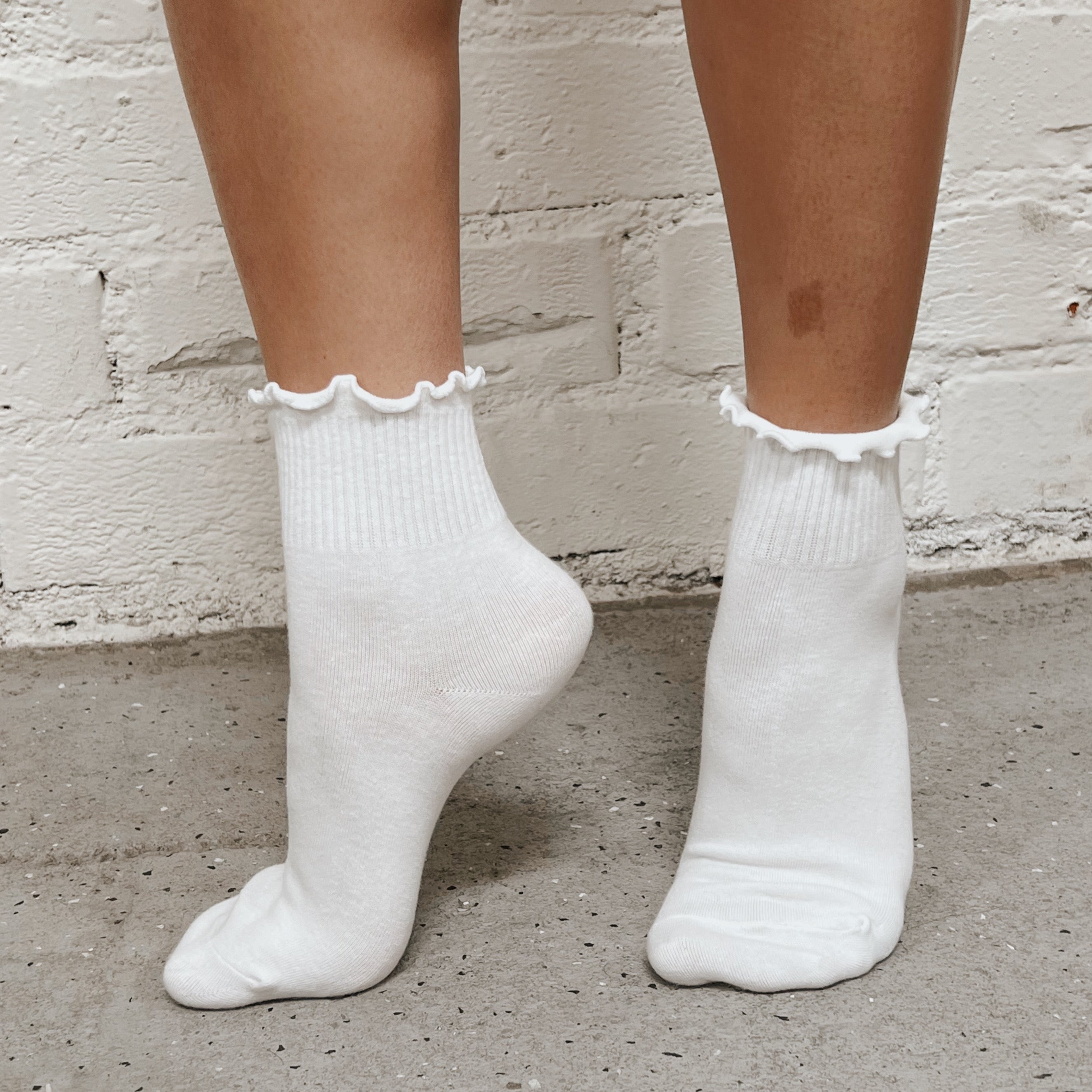 Girl wearing white ruffle socks