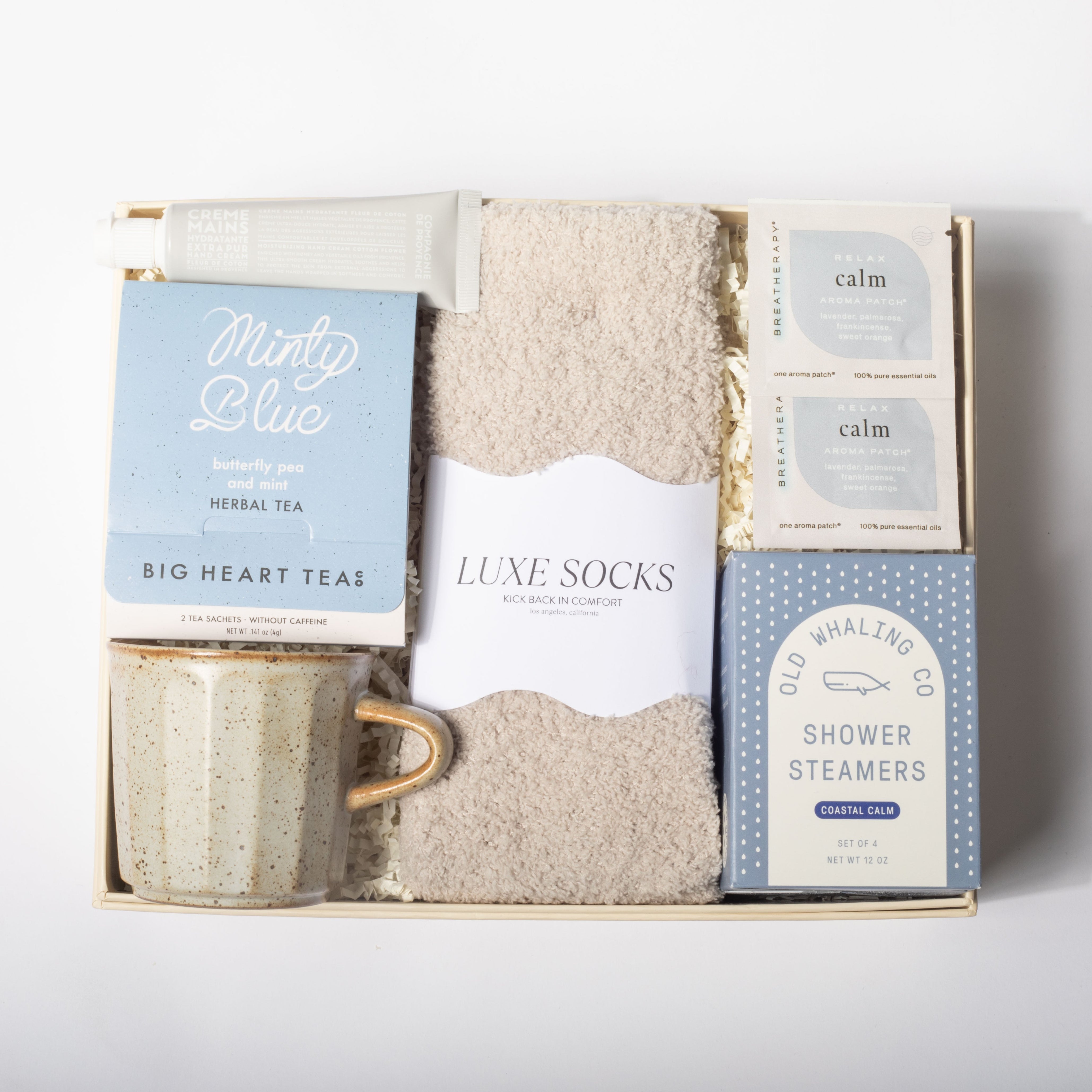 Gift set with mug, socks, and shower steamers on a white background