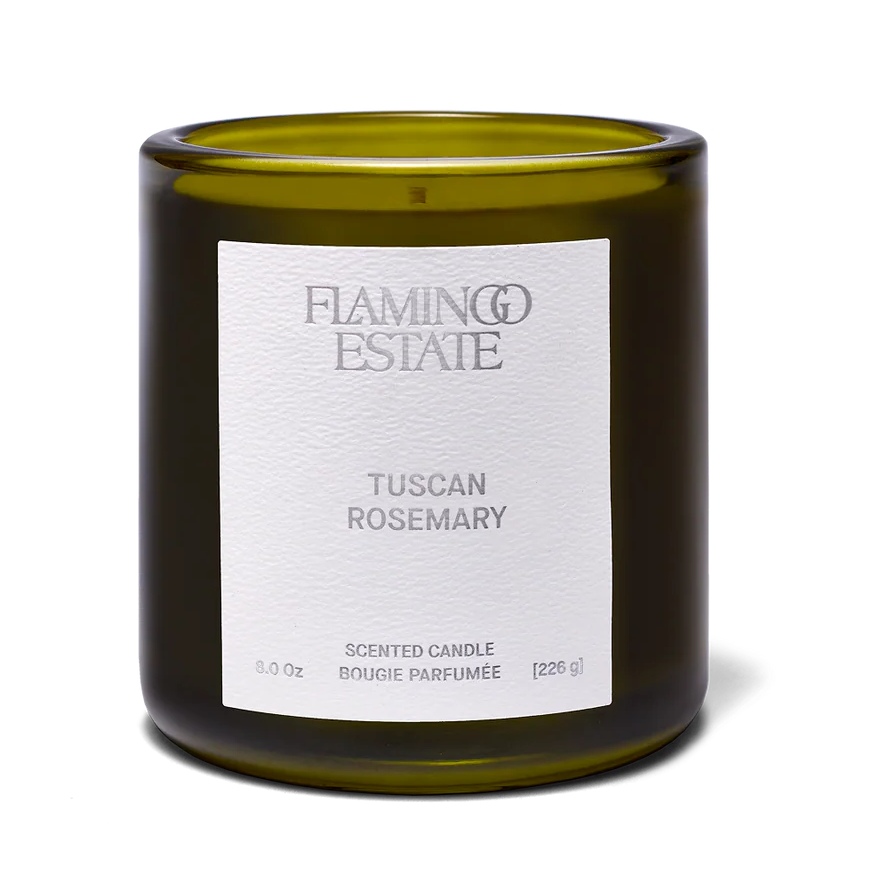 Green candle with a white label on a white background