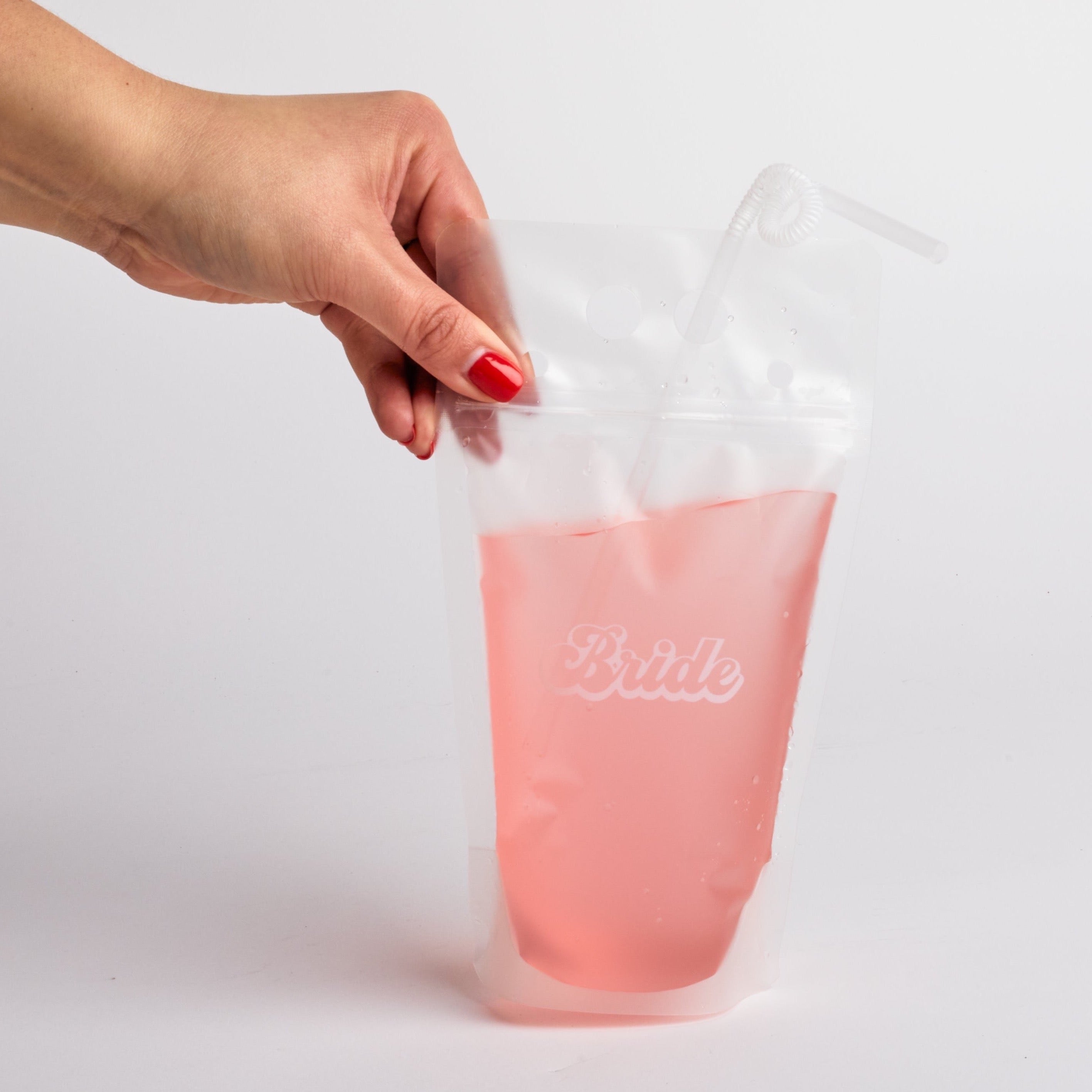 Hand holding "bride" drink pouch.