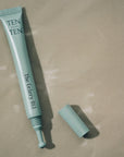 Teal skincare product tube labeled 'TEN' on a beige background