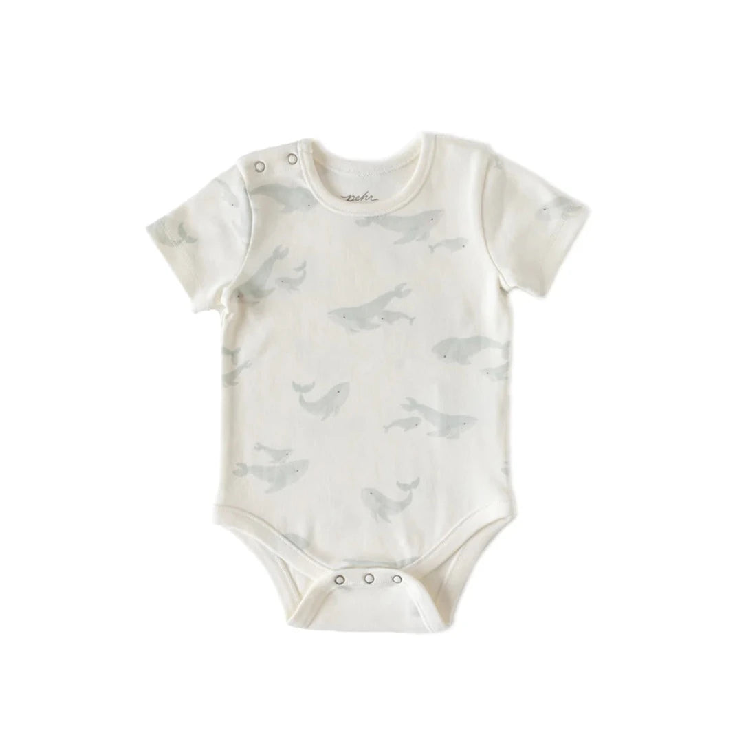white one piece with gray whales printed on it
