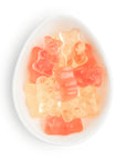 Gummy bears in a white dish on a white background