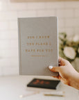 hand holding chambray fabric journal that says "FOR I KNOW THE PLANS I HAVE FOR YOU' on it