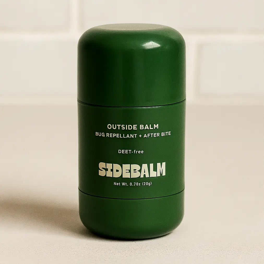 Green container of SideBalm Outside Balm on a beige background