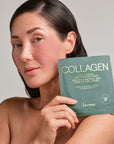 Woman holding a package of Karuna Collagen patches against a neutral background