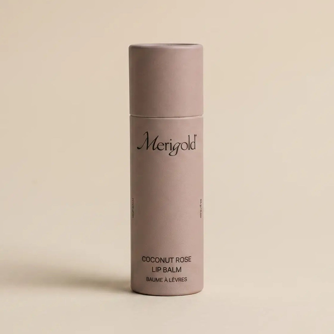 coconut rose lip balm on a tan background