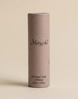coconut rose lip balm on a tan background