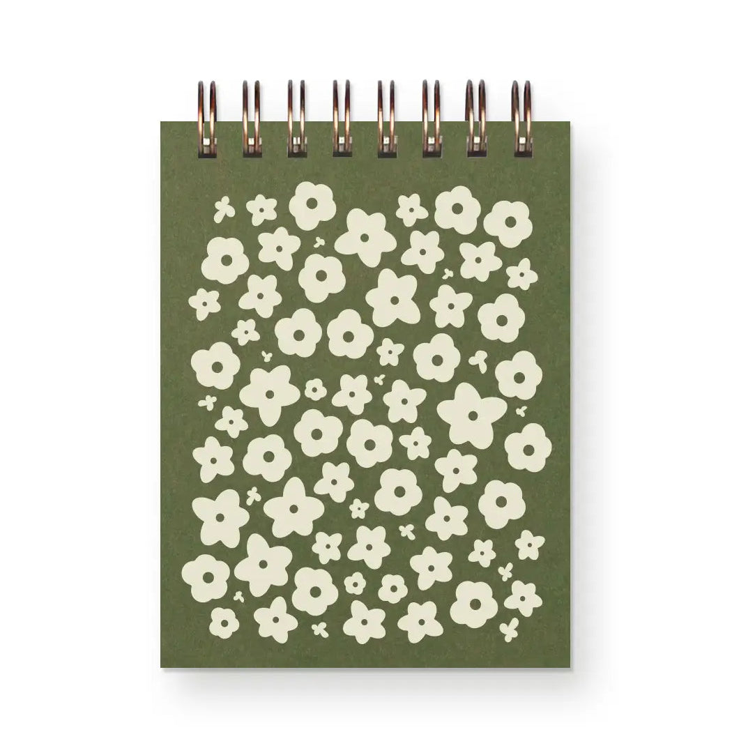 green flower pattern notebook on a white background