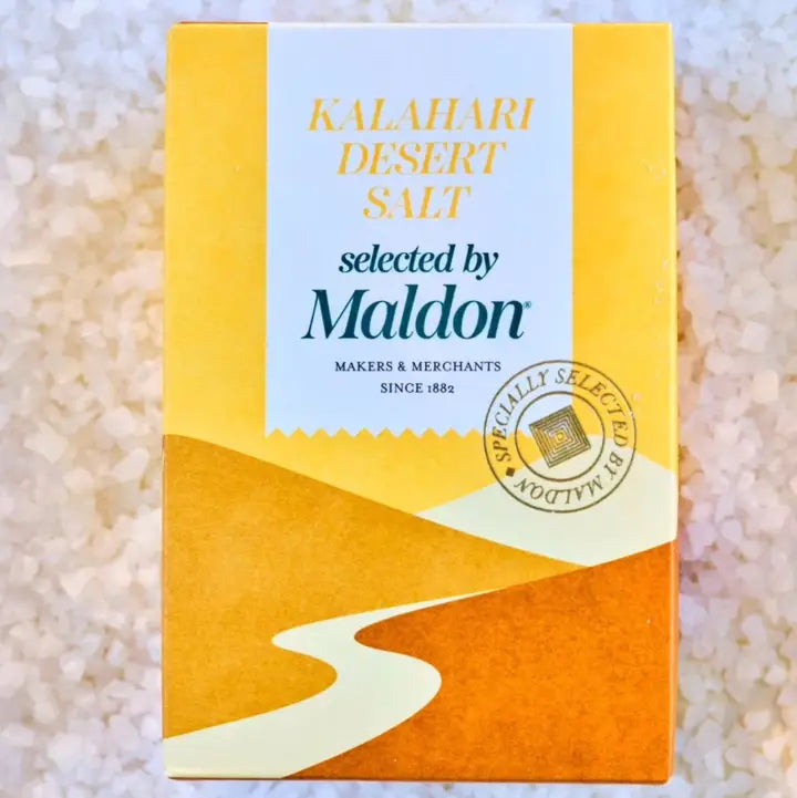 Box of Kalahari Desert Salt selected by Maldon on a sandy background