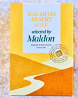 Box of Kalahari Desert Salt selected by Maldon on a sandy background